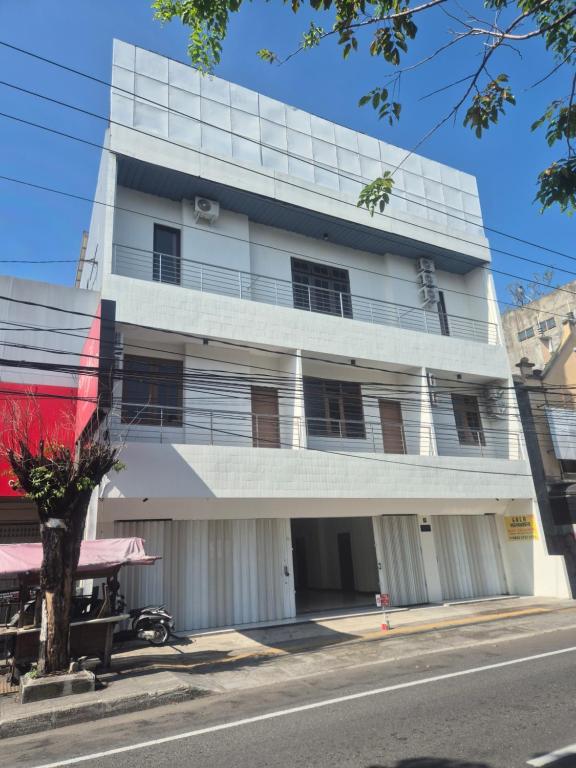 a white building on the side of a street at ERCA Yogyakarta in Yogyakarta