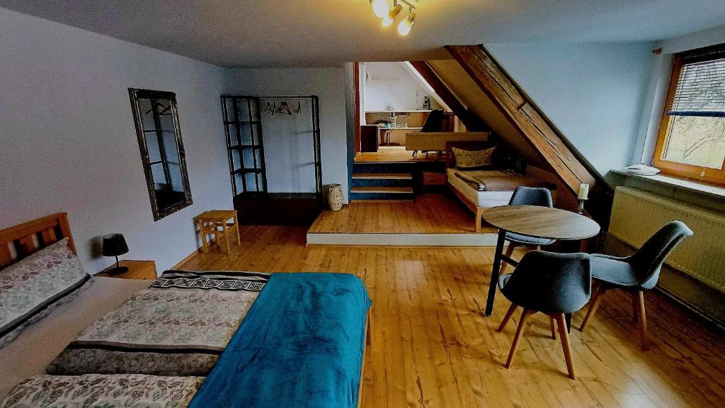a bedroom with a bed and a table and a couch at Sonnentor in Bad Wurzach