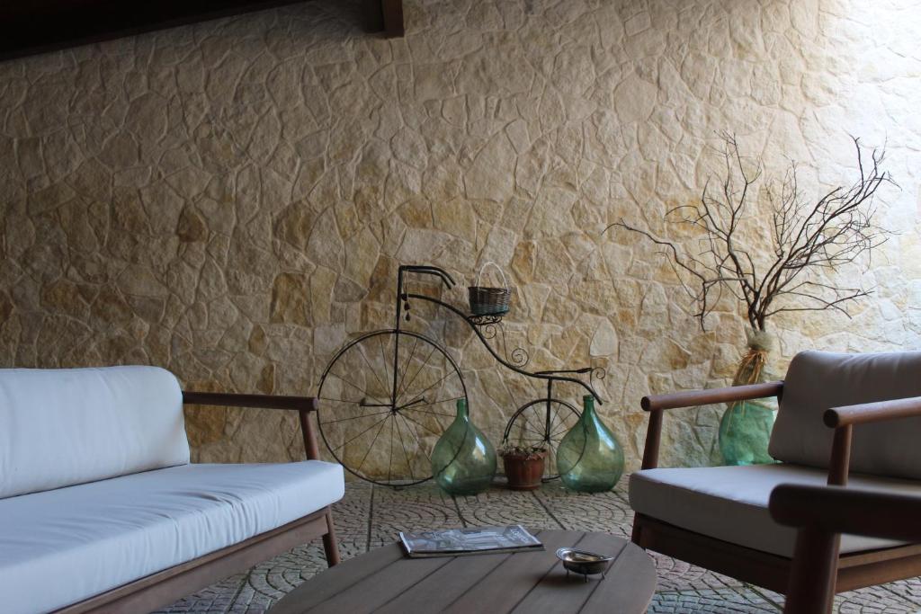 a living room with a couch and a bike on the wall at Le Casette della Murgia in Cassano delle Murge