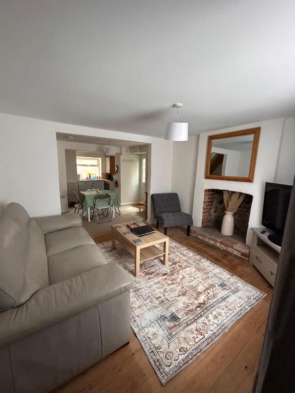 a living room with a couch and a table at Mundesley Cosy cottage in Mundesley