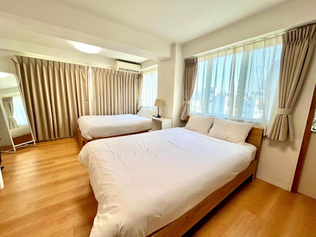 a hotel room with two beds and a window at Rhodes Kagurazaka in Tokyo