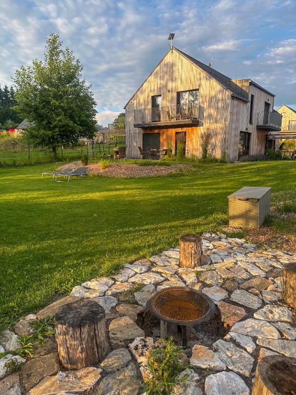 a large barn with a fire pit in the yard at Nora Apartments in Dolní Morava