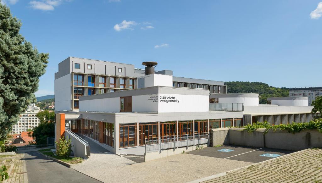 a large white building with a lot of windows at Centre International de Séjour André Wogenscky in Saint-Étienne