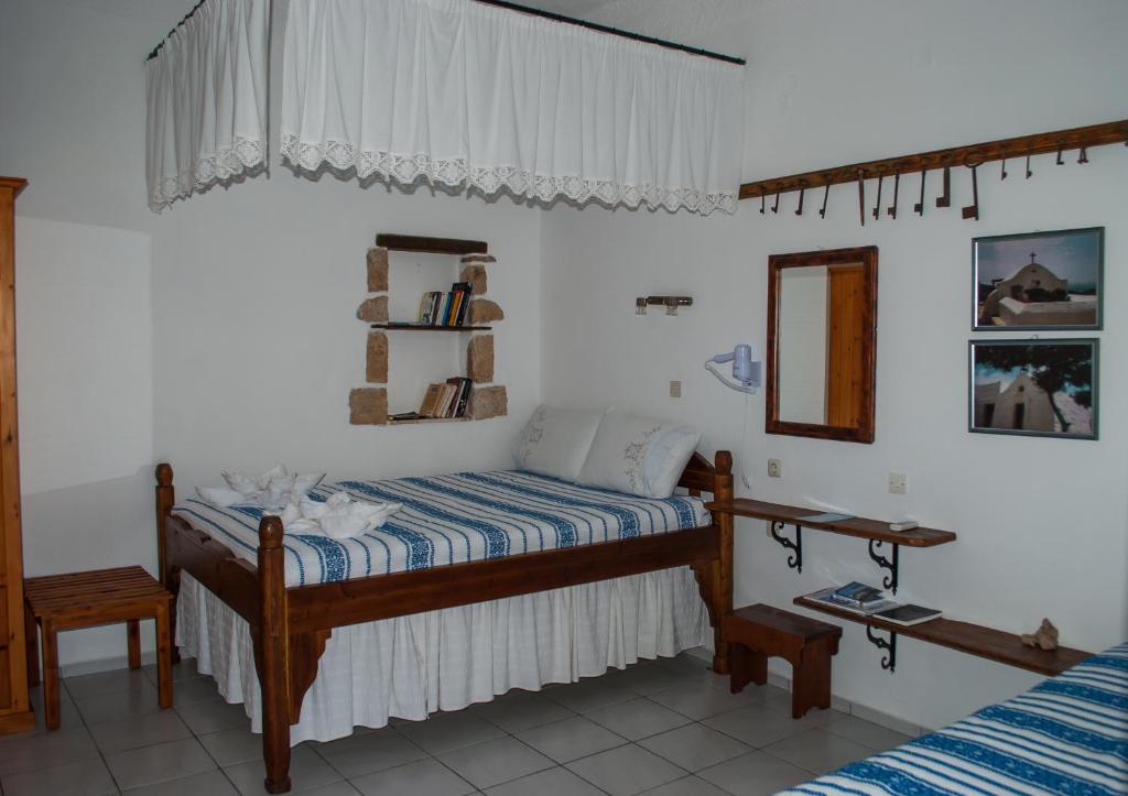 sypialnia z dwoma łóżkami i lustrem w obiekcie PATMOS Mathios Studios- apartments w mieście Patmos