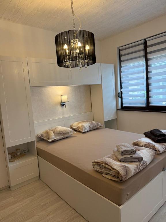 a bedroom with a bed with two pillows on it at Z-apartment in Tryavna in Tryavna