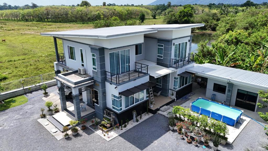 an aerial view of a house with a swimming pool at Home Valot Bed and Breakfast in Lan Saka