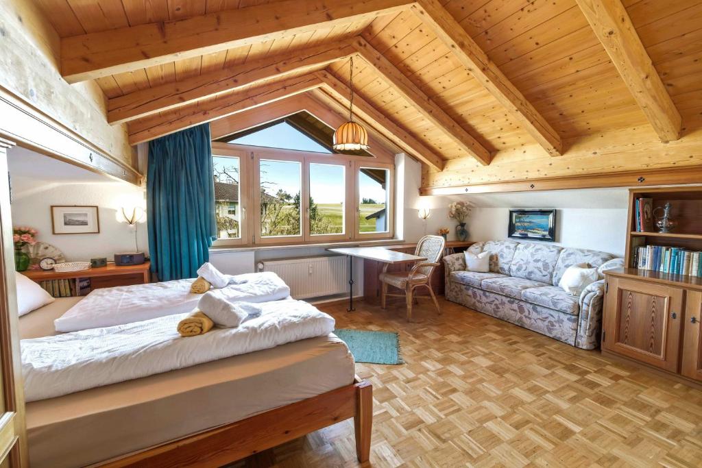 a bedroom with a bed and a living room at Rosi's Ferienwohnung Kampenwandblick in Prien am Chiemsee