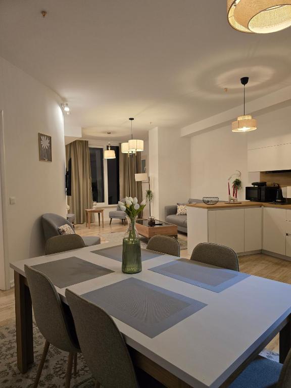 a kitchen and living room with a table and chairs at Budva Central Escape Apartment in Budva