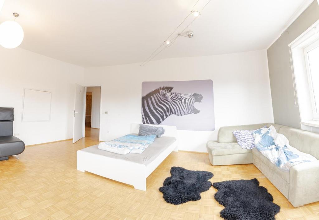 a living room with a couch and a zebra picture at Vacation, Work, Party in Allerstorf