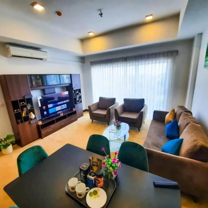 a living room with a couch and a table at Negombo Sea waves in Negombo