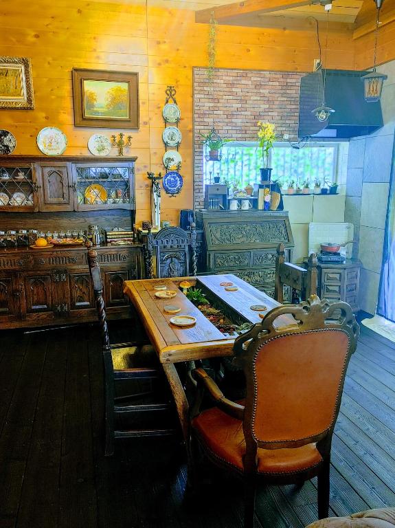 a kitchen with a wooden table with chairs and a counter at Kirisame Magic Shop霧雨魔法店民泊伊勢市 in Ise