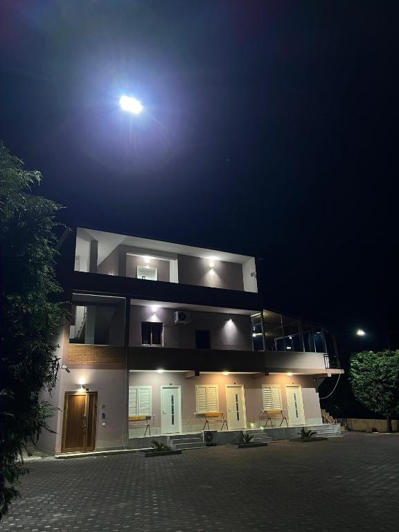 a building with a light on top of it at night at Alessio Rooms Kruja in Krujë
