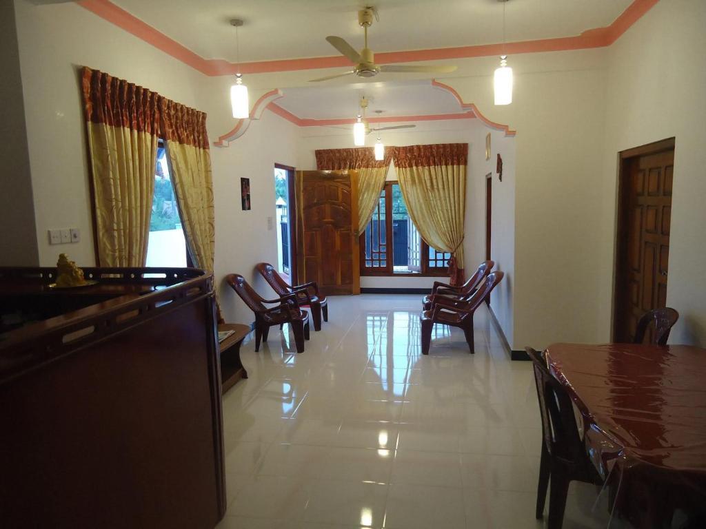 a dining room with chairs and a table in a room at Blue Moon Rest Inn in Trincomalee