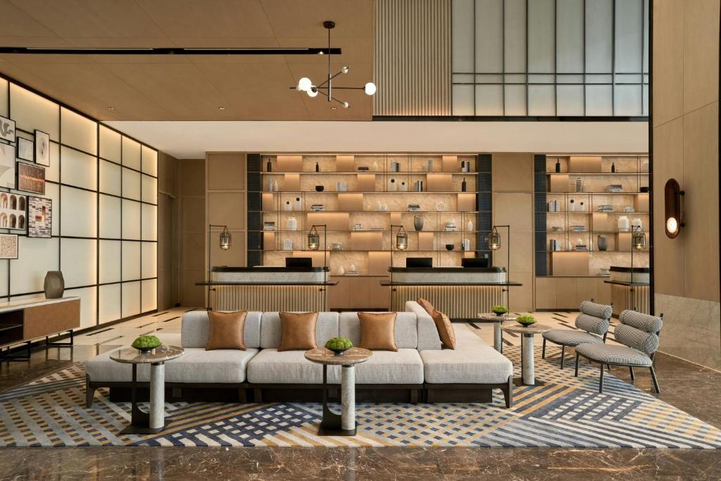 a living room with a couch and some chairs and tables at Sheraton Vinh in Yên Thinh (1)