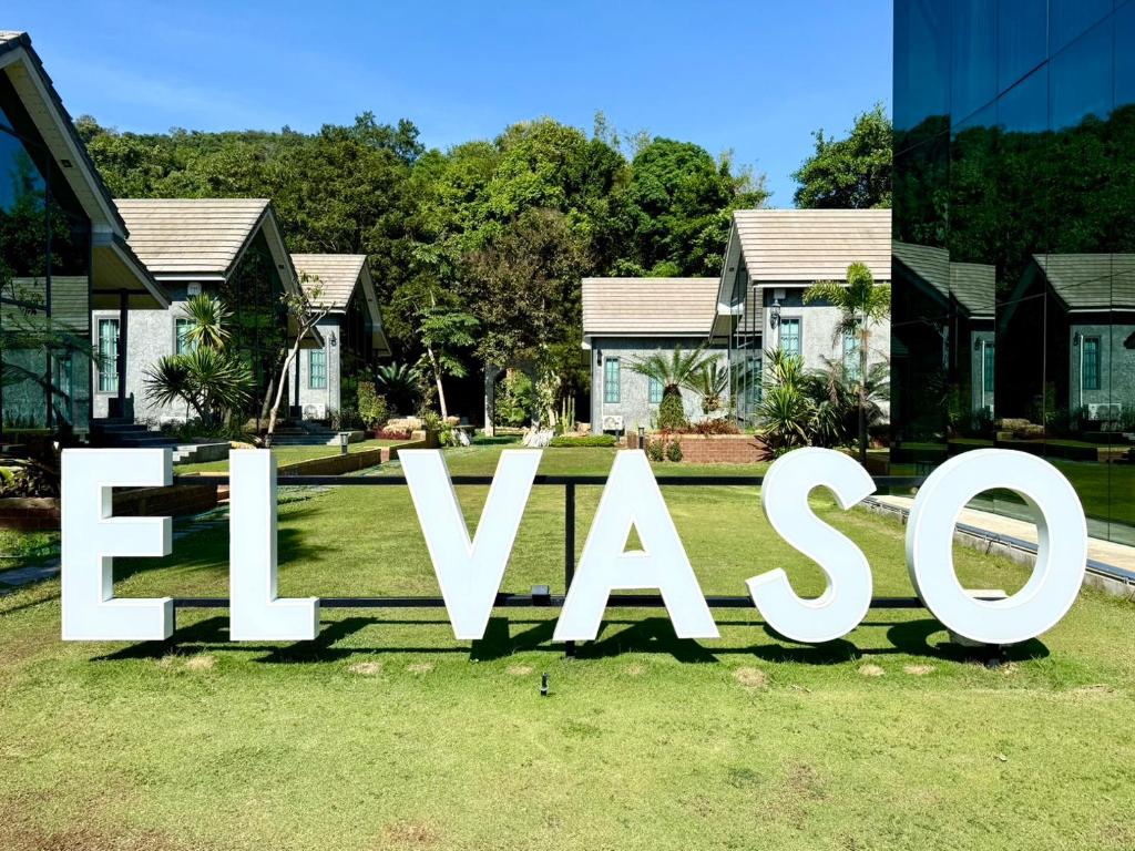 a large sign in front of a house at El Vaso Resort in Chanthaburi