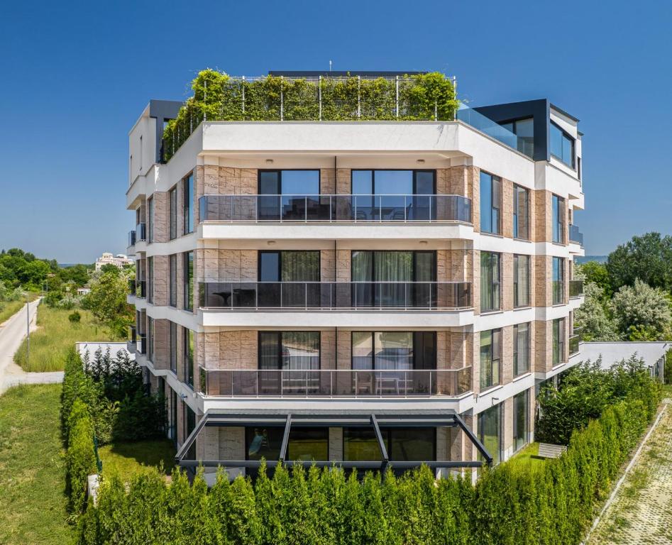 an apartment building with plants on top of it at AthmosphereVillaEma Apartments in Kranevo