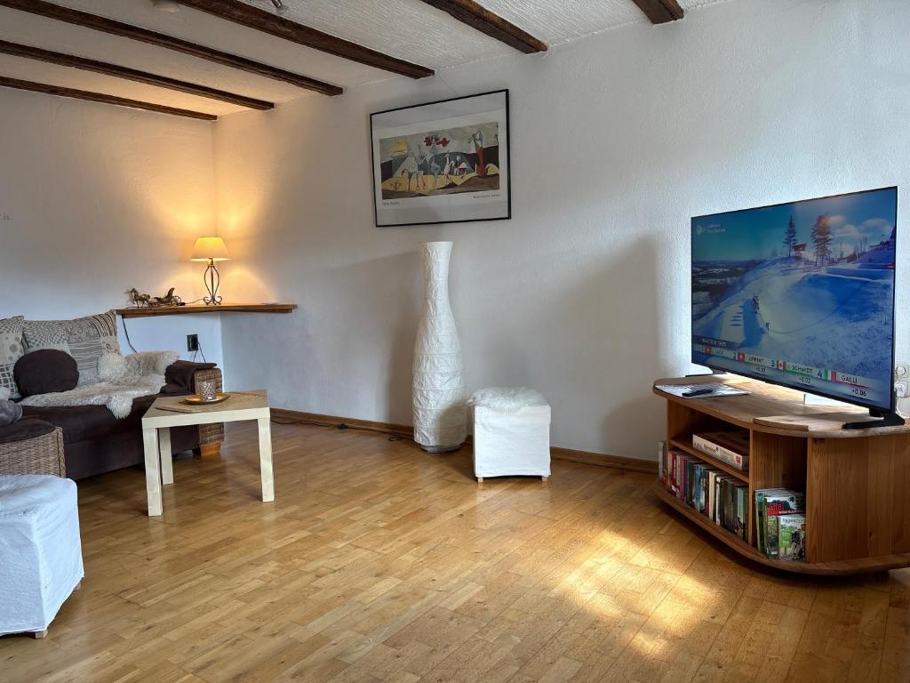 a living room with a large flat screen tv at Ferienhaus Eifelperle in Blankenheim