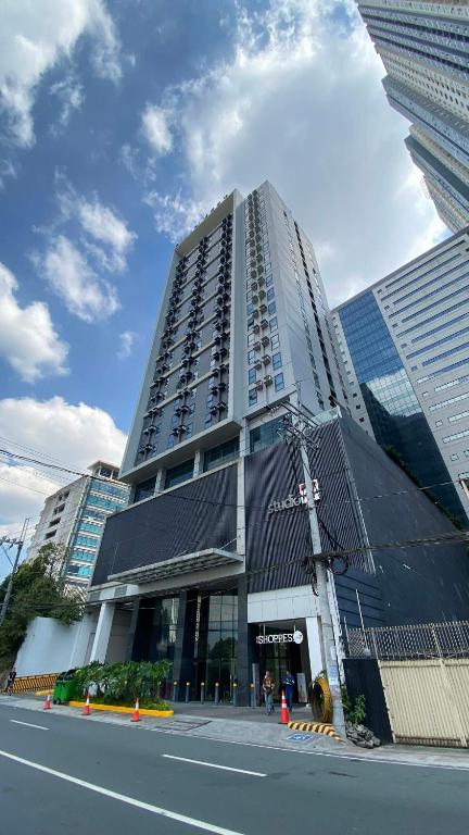 a tall building on a city street with at Bright Nook in Manila