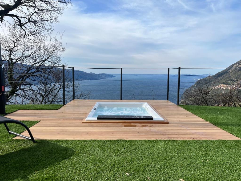 a hot tub sitting on top of a wooden deck at Villa dei Roveri in Tignale