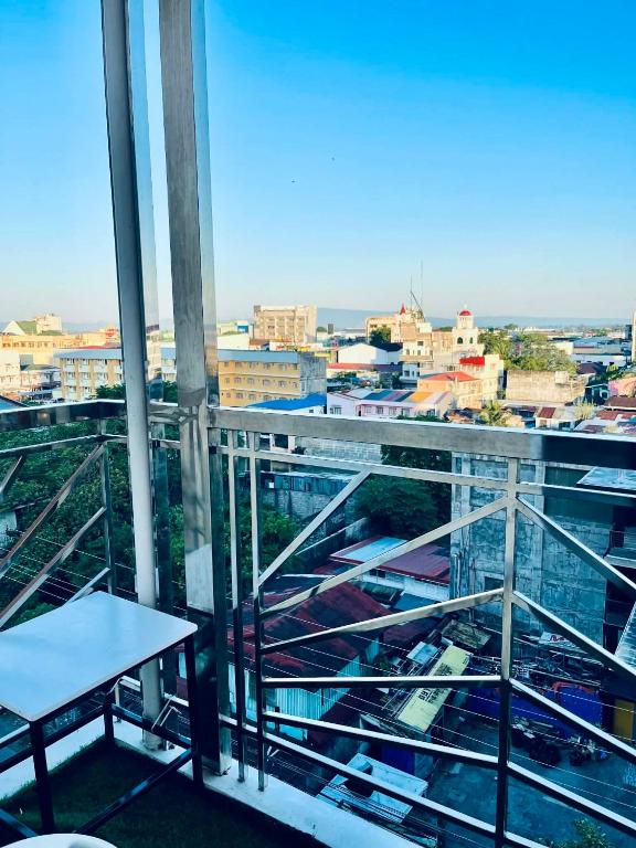 a balcony with a table and a view of a city at NagaCityRiverView 2BR Apartment in Naga
