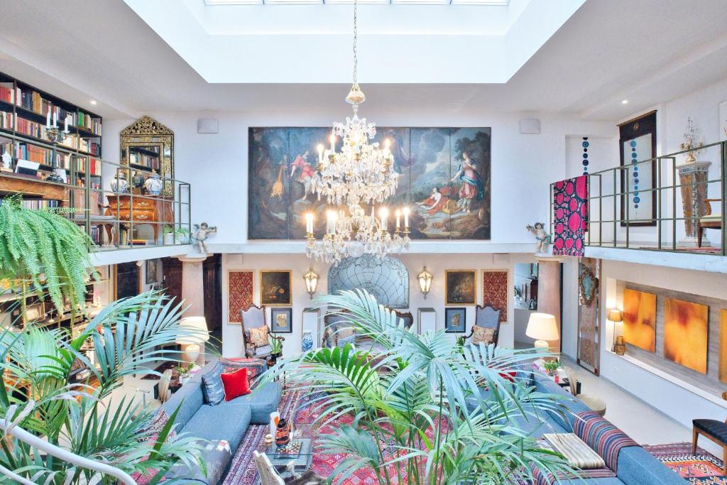 a large room with plants and a chandelier at Historic Cinema Suite with Private Art Collection - Basel in Basel