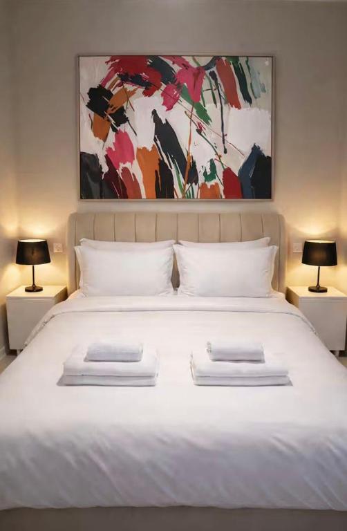 a large white bed with two pillows on it at Soydan World Travel in Antalya