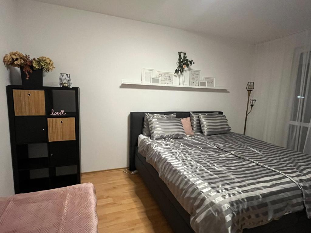 a bedroom with a bed with two pillows on it at Harmony Apartman in Dunajská Streda