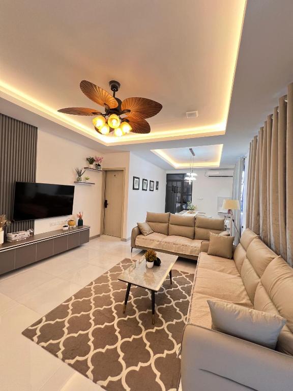 a living room with a couch and a tv at Foavahi Shark View Inn in Fuvahmulah