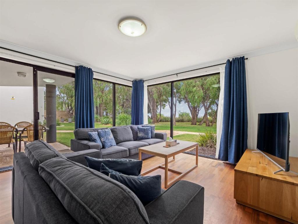 a living room with a couch and a tv at 1CapeView beachfront Geographe Bay in Broadwater