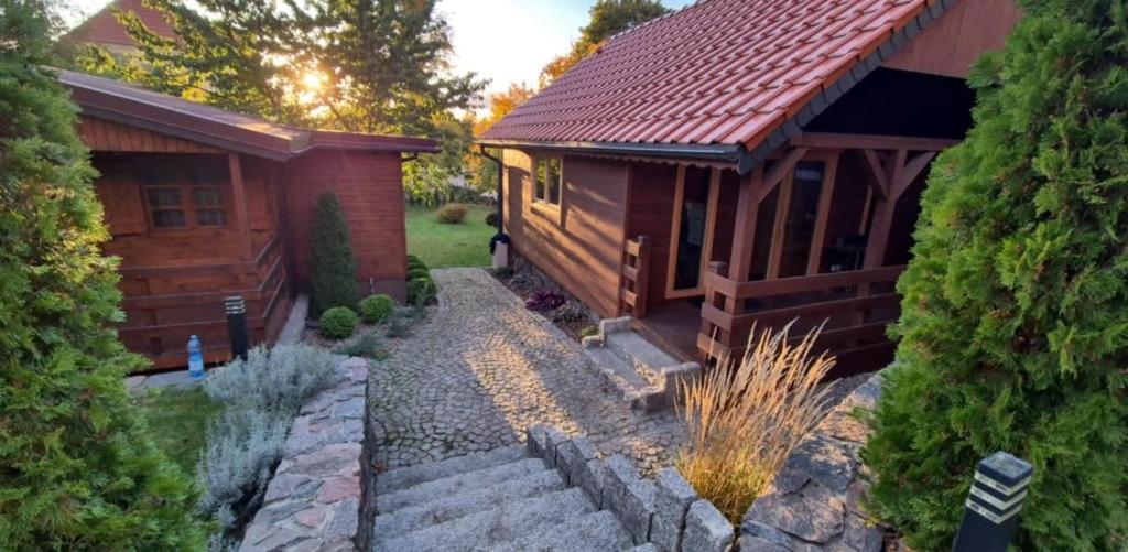a home with a stone path leading to a house at Mazurski Domek in Mikołajki