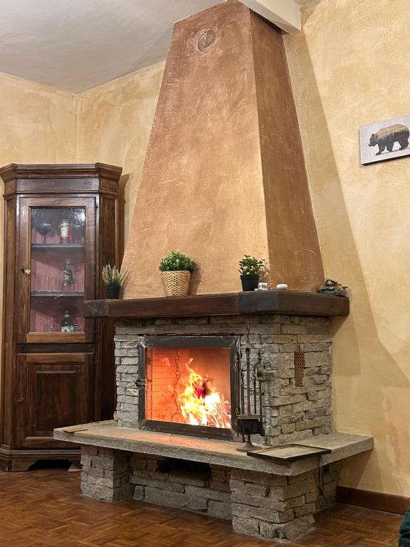 a stone fireplace in a living room with at Il caminetto in Pradleve