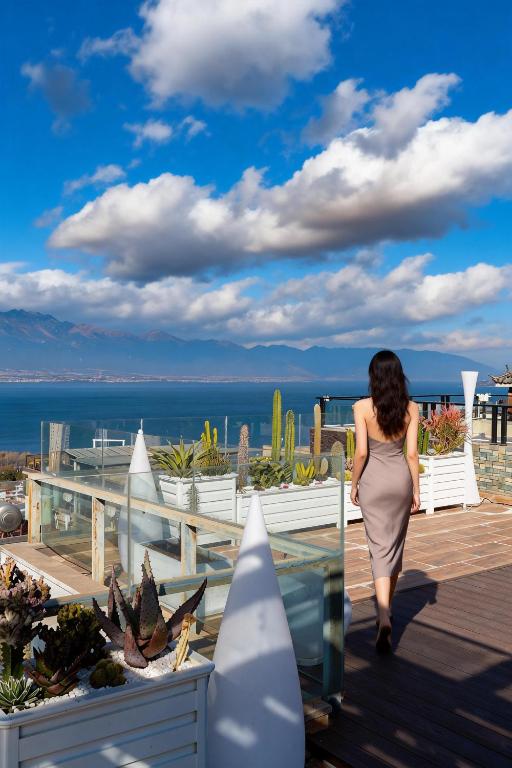 a woman in a dress walking down a wooden deck at 云顶海景设计师别墅Yunding Seaview Designer Villa in Dali