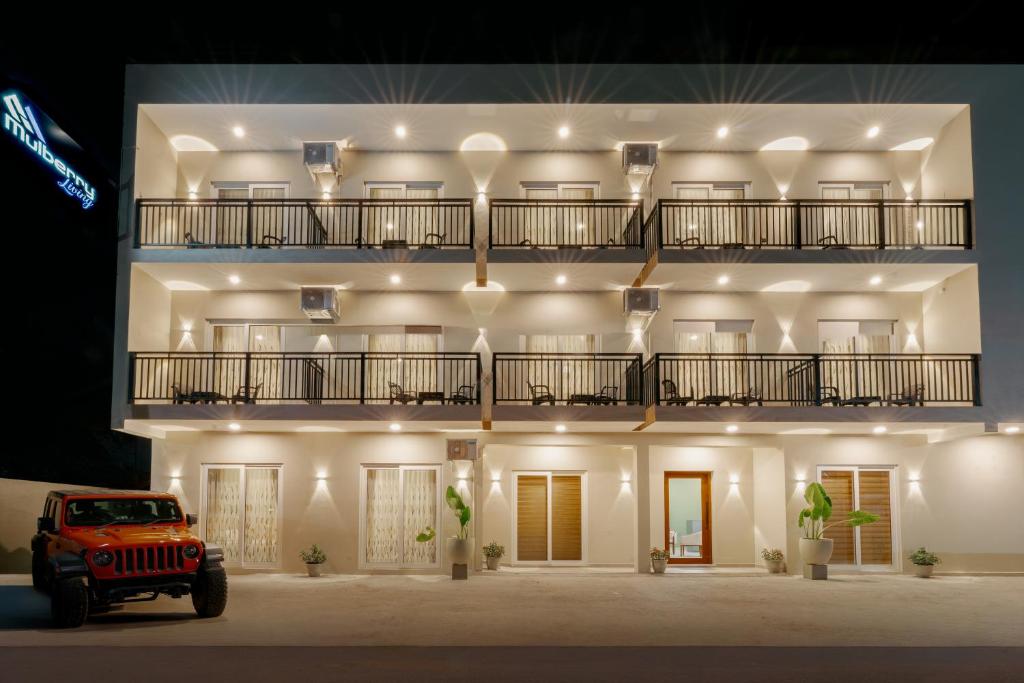 a red jeep parked in front of a building at Mulberry Living in Negombo