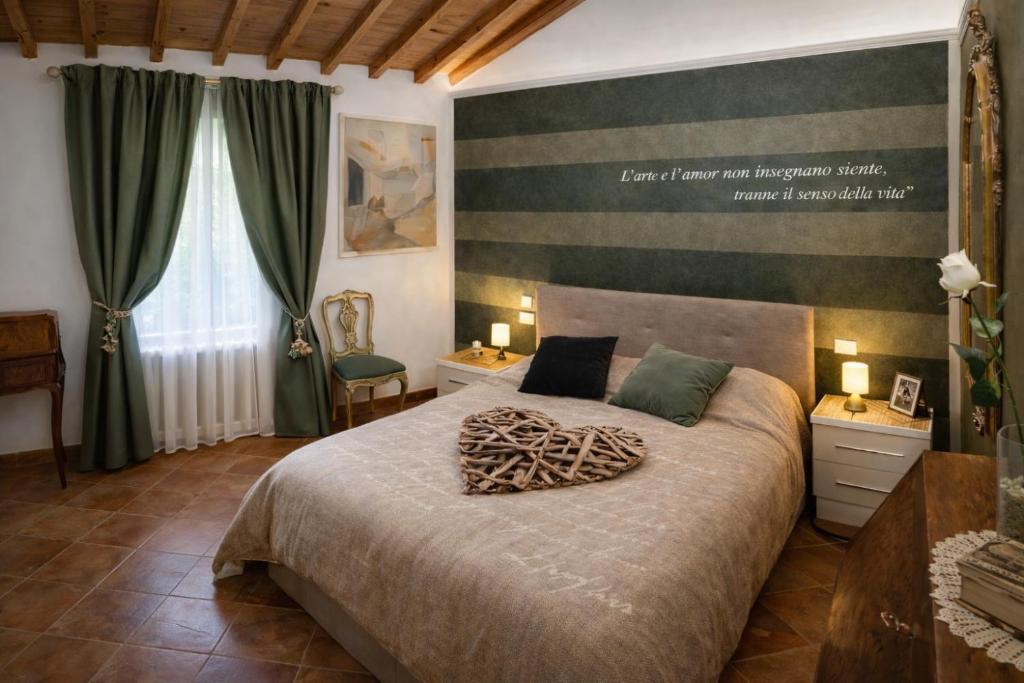 a bedroom with a large bed in a room at La Suite dei Ricordi tra Firenze e Chianti relax arte storia in Impruneta