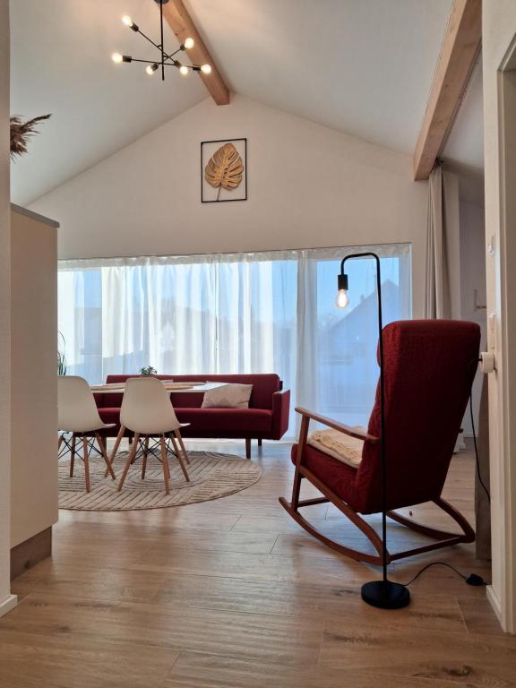 a living room with a red couch and chairs at Apartment Romi in Bad Waldsee