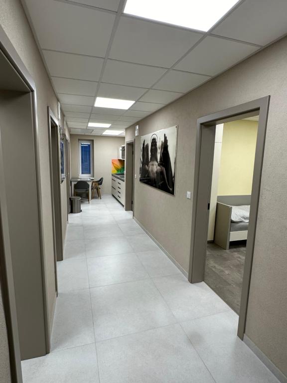 an empty hallway in an office with a room with a bed at Fully Equipped Guest House Košice-Barca in Košice