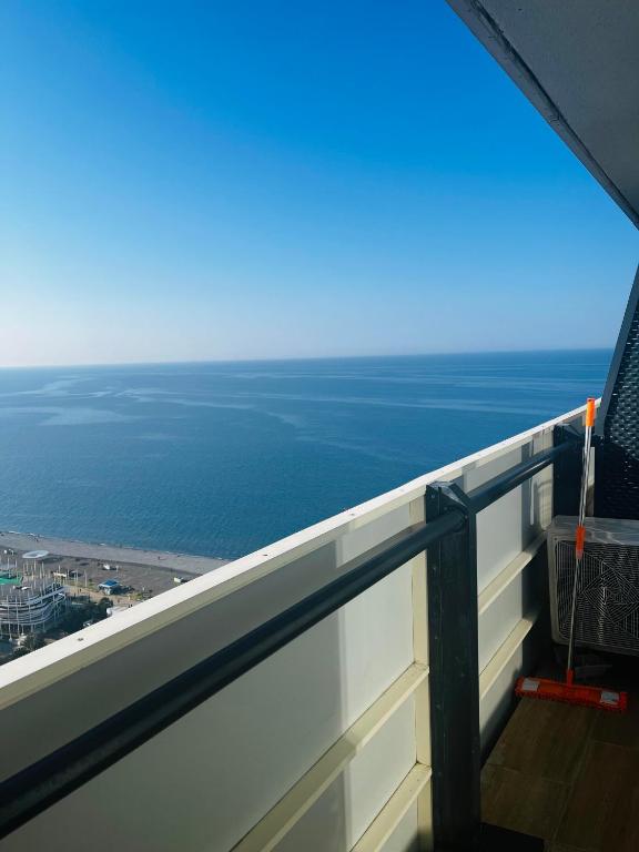 a view of the ocean from a balcony of a building at New Orbi City Luxury Suites in Batumi