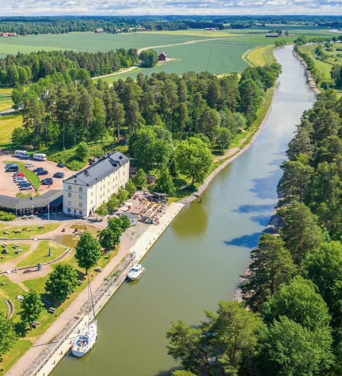 an aerial view of a river with a building at Norrqvarn Hotel & Resort by Vänerport in Lyrestad