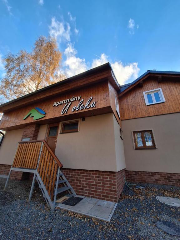 a building with a sign on the side of it at Apartmany U vleku 6 in Ceske Petrovice