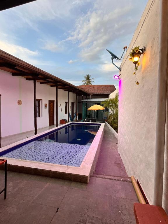 a swimming pool next to a building with a house at Casa Samuel in Honda