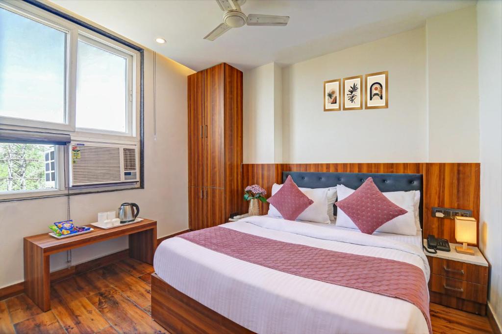 a bedroom with a large bed and a window at Hotel City inn in New Delhi
