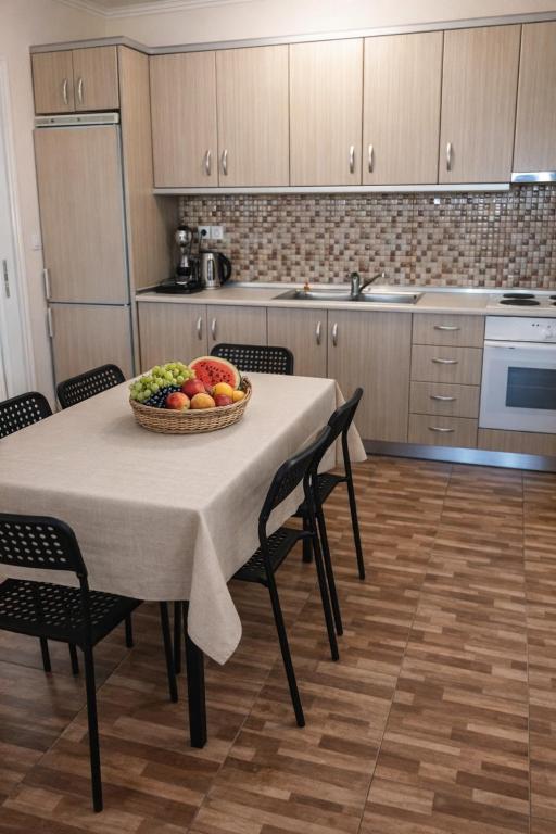 a kitchen with a table with a bowl of fruit on it at Farma Giannis in Sarti