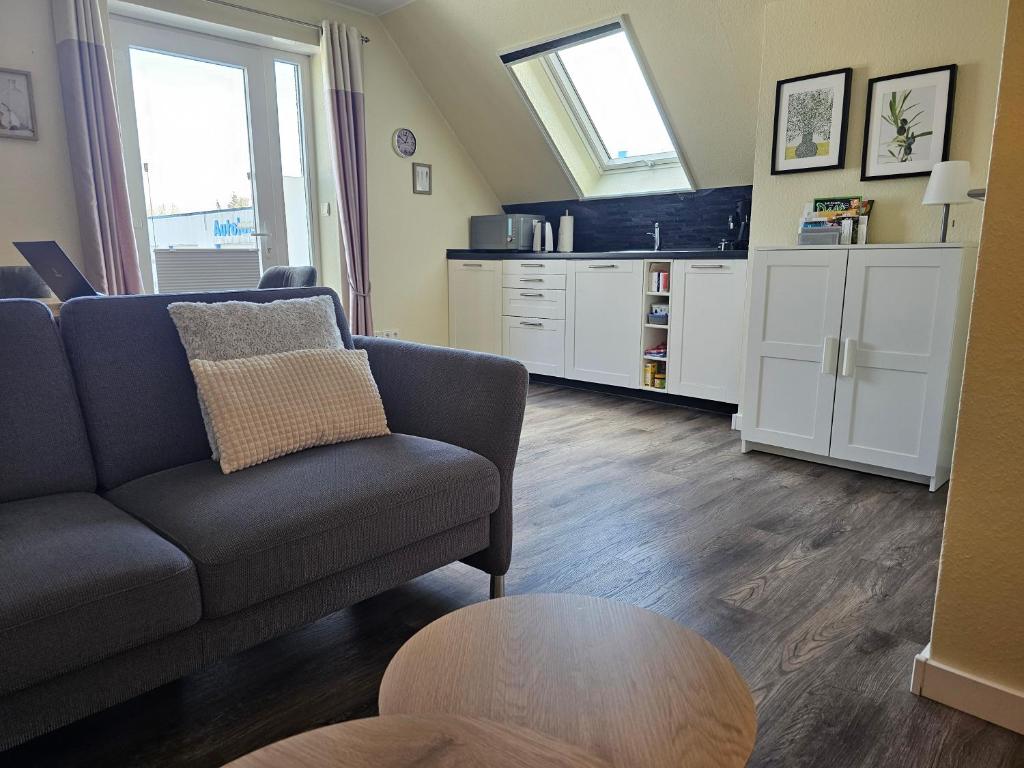 a living room with a couch and a table at Moderne Ferienwohnung "Adriane" mit gehobener Ausstattung - Top bewertet in Nordhorn