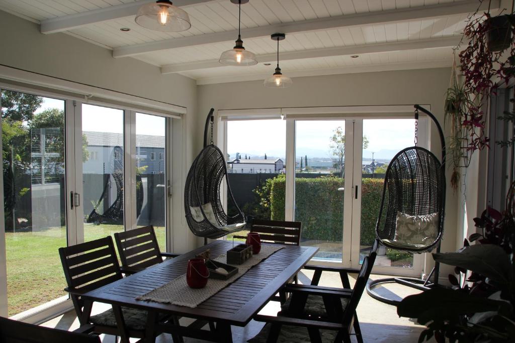 a porch with a table and chairs and windows at Logans Place in Oakdale