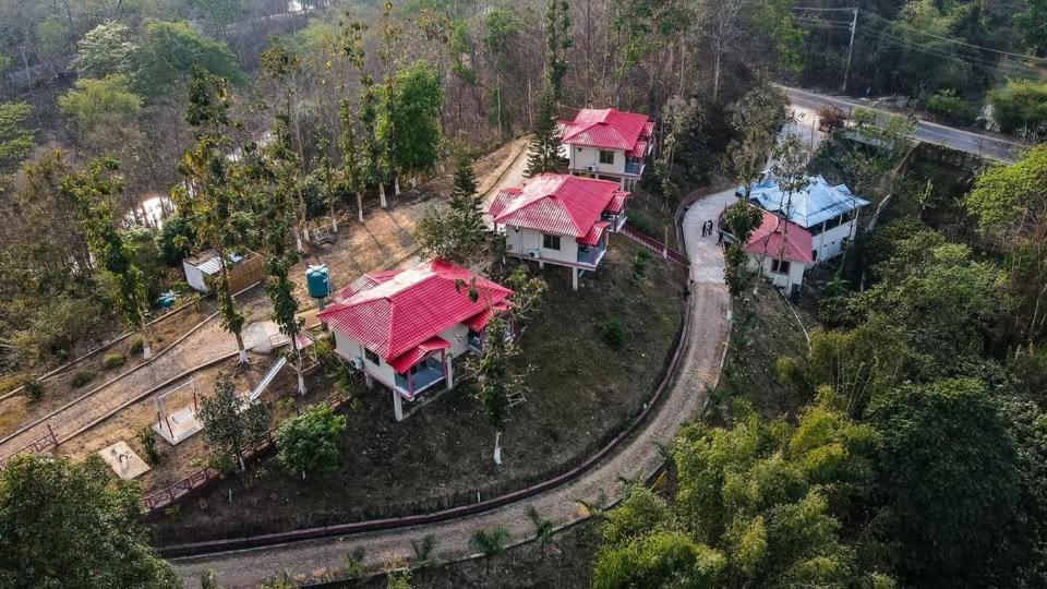 an overhead view of a group of houses with red roofs at Mountain Springs Resort in Bāndarban