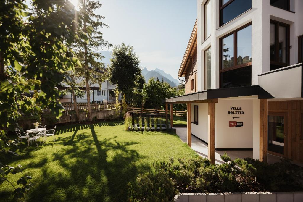 a view of a yard with a house at Villa Melitta in San Vigilio Di Marebbe