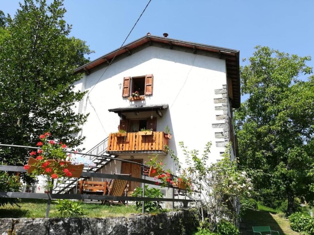 a white house with a balcony and a window at Il Borgo Don Camillo in Pian di Novello
