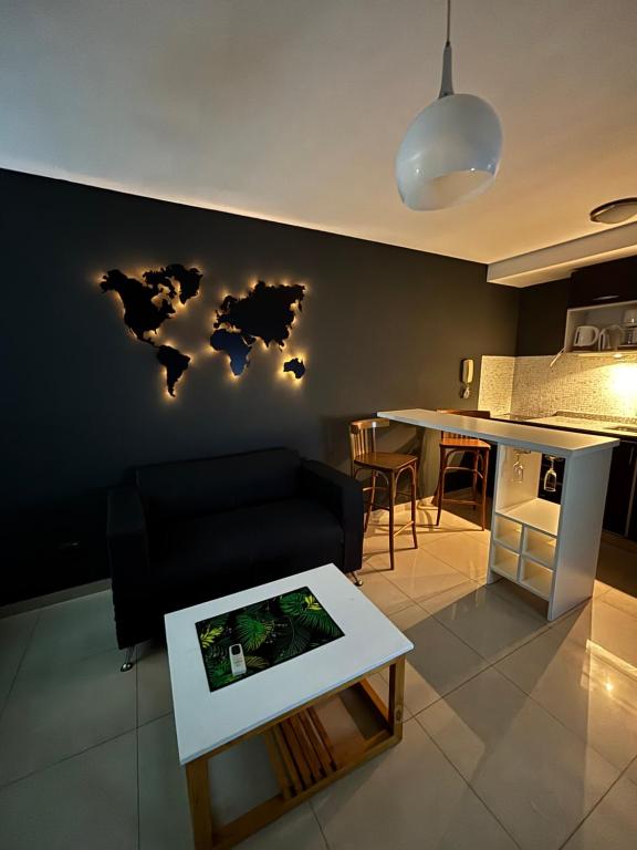 a living room with a map of the world on the wall at Ballester apart piscina in Villa Ballester