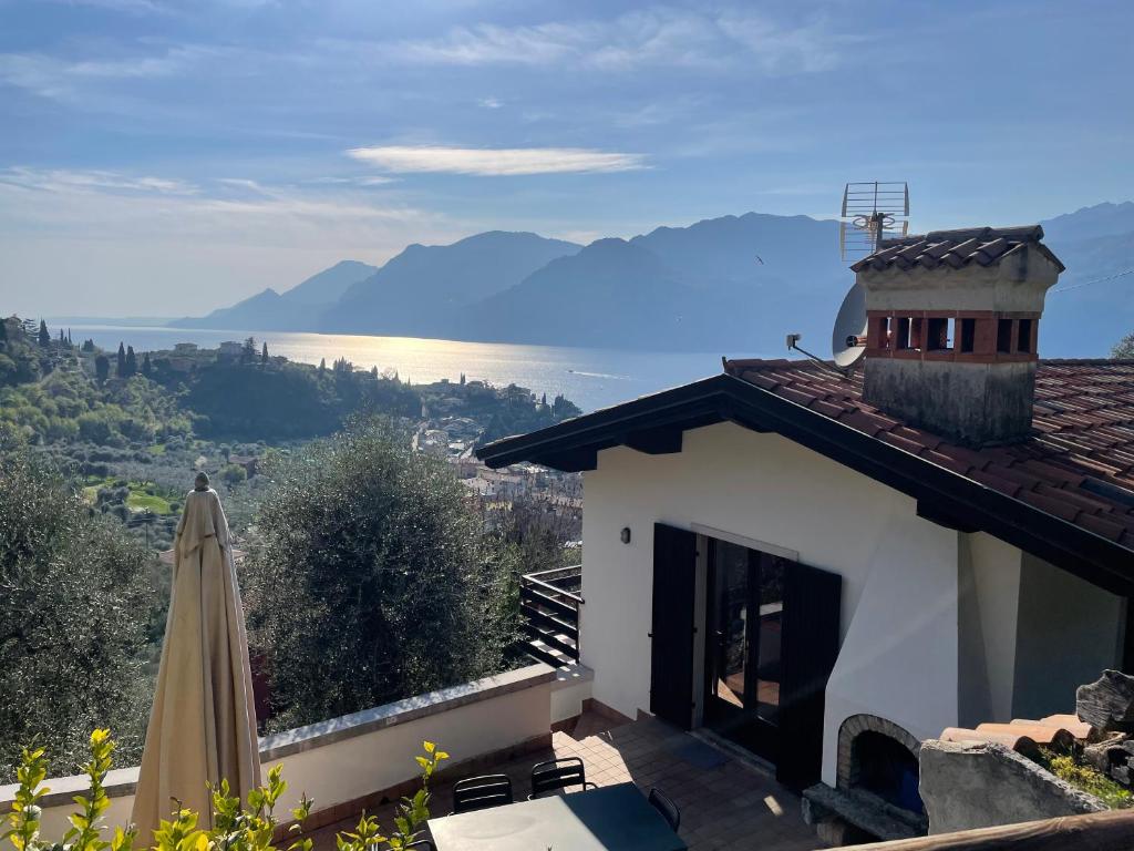 a building with an umbrella and a view of the water at Etti's House in Malcesine