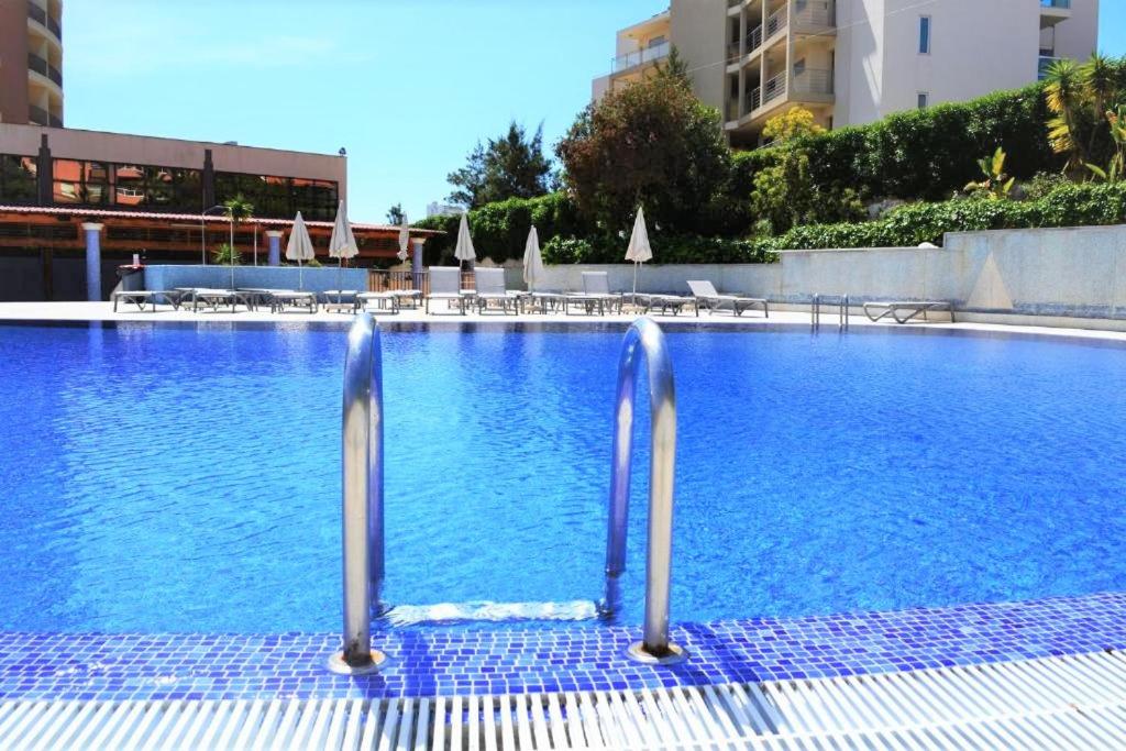 a large swimming pool with blue water in a building at Da Rocha Beach 8, SEA VIEW in Portimão